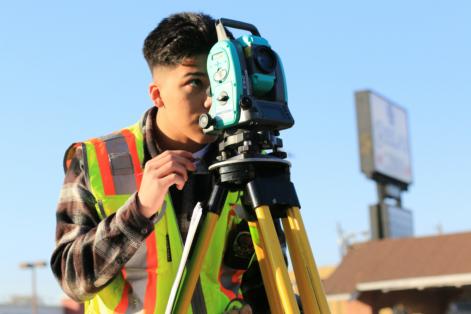 Surveyor working outdoors; illustrative image, not the Diani property or participants