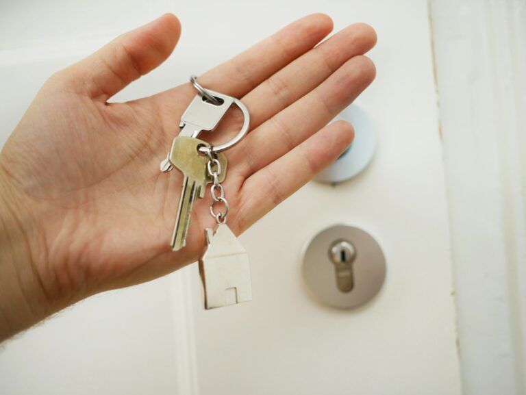 A hand holding a door key